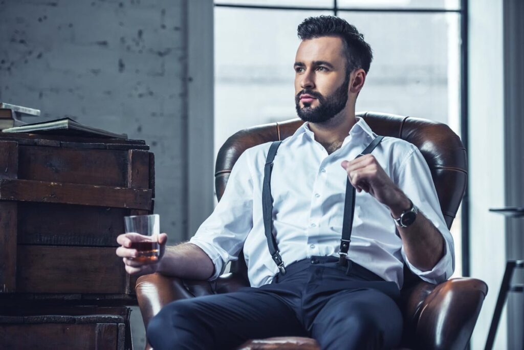 a business man drinking a glass of wine